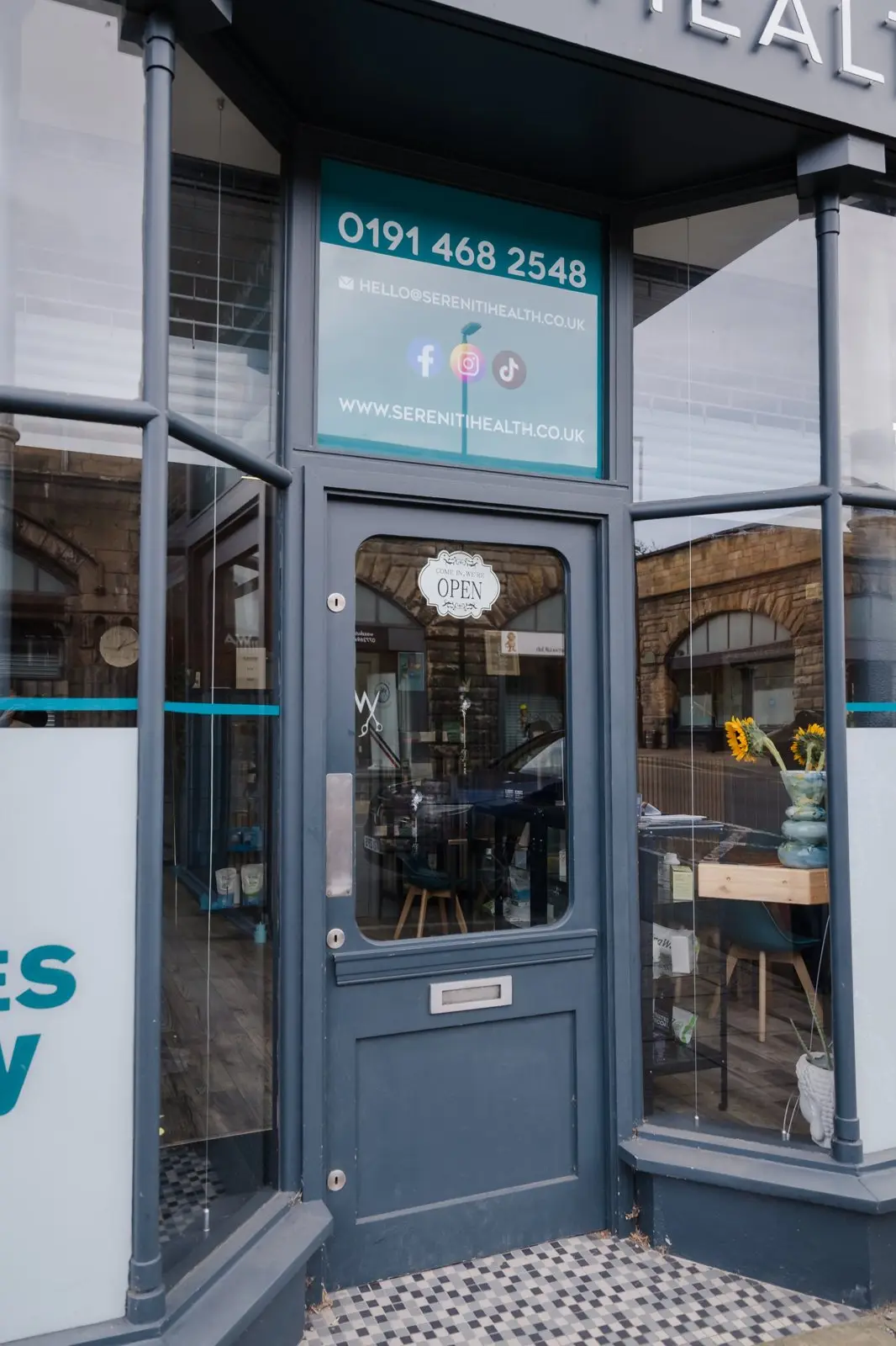 The front door of Sereniti Health, with the open sign in the window